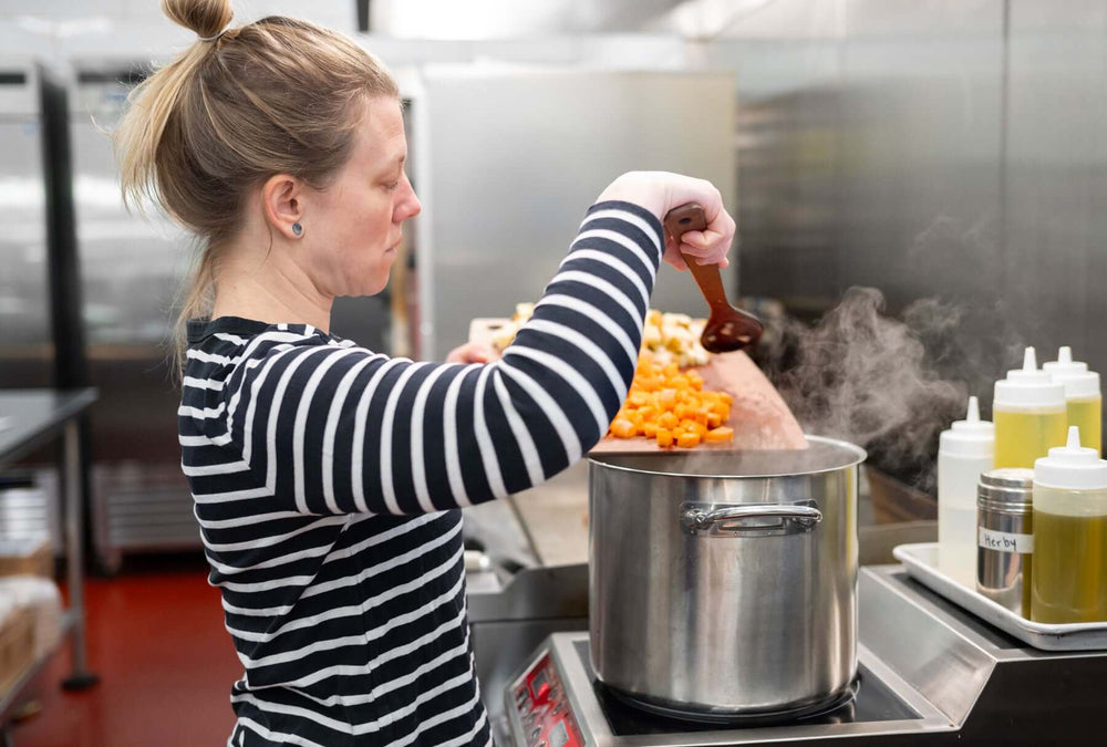 Chef Erin Palombo with a Kitchen Series Cutting Board and Kitchen Series Medium Spoon