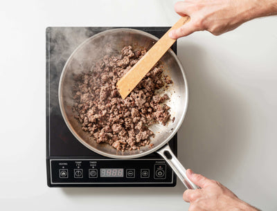 Epicurean Cool Tool in Natural being used to sauté some ground beef 